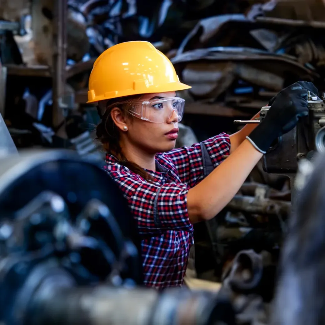 engineer-woman-1147555040 Young Engineer woman working with machine in factory.