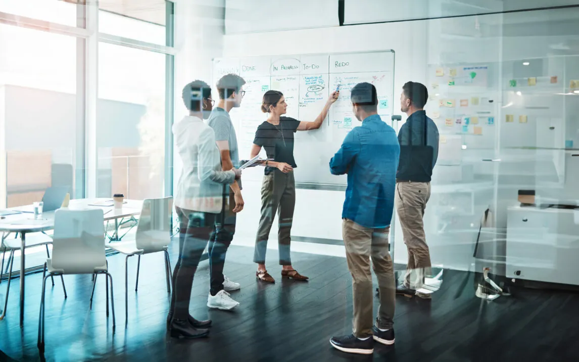 group-of-business-people-having-a-meeting-1147479610 Shot of a group of businesspeople having a meeting in a modern office