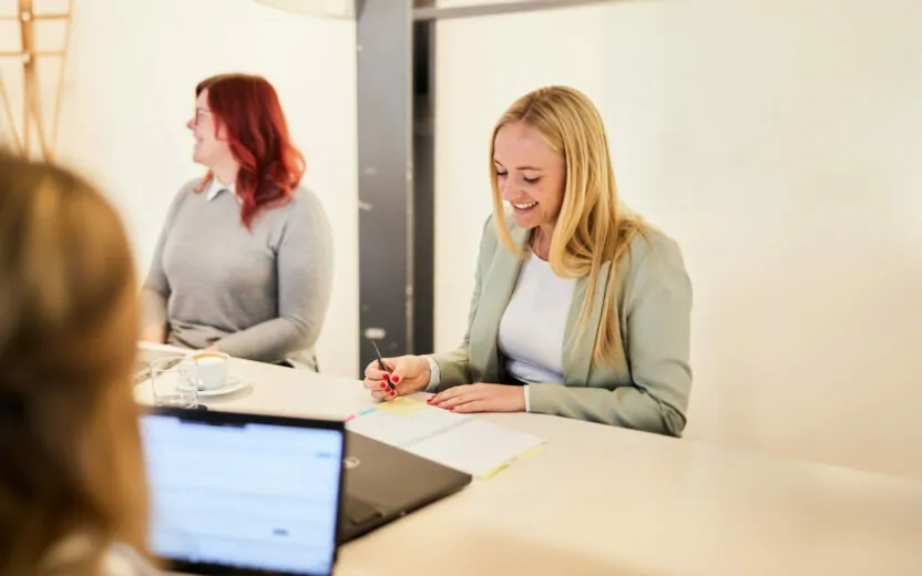 valantic employee writing notes in meeting