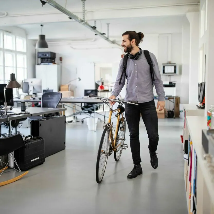 businessman-with-a-bicycle-in-office-1212006372 Businessman with a bicycle in office
