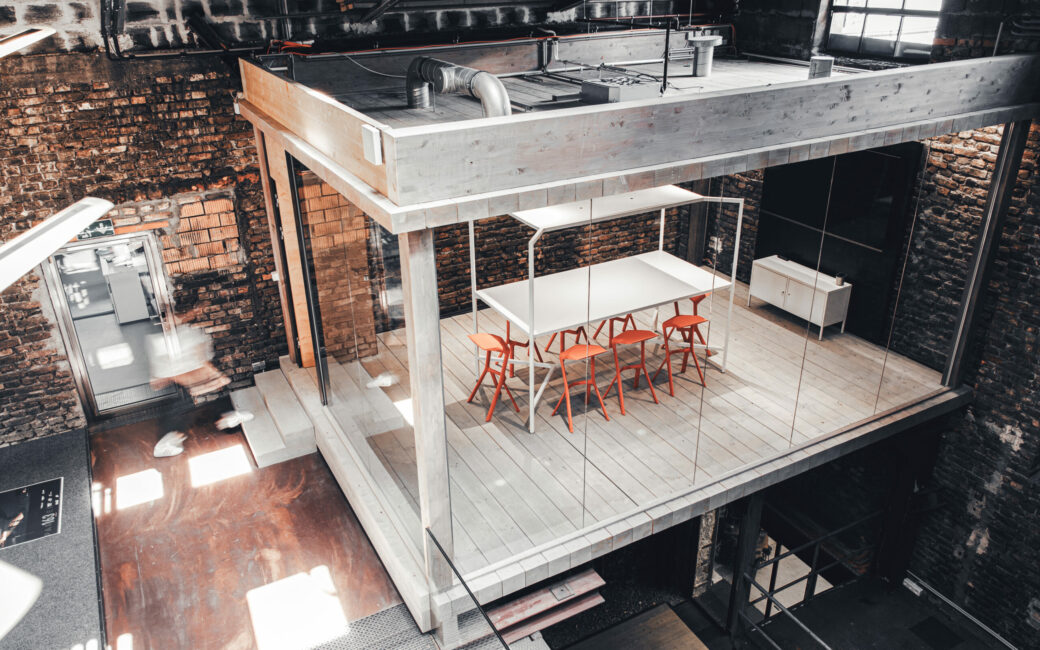 Top view of a modern meeting room with orange chairs.