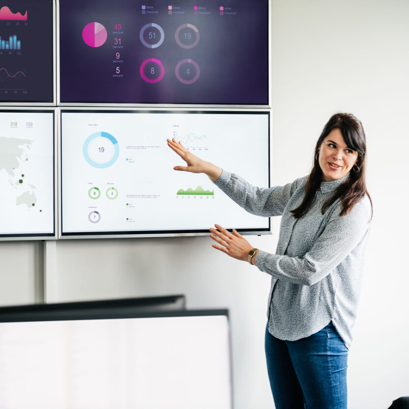 Businesswoman explaining graphs and data Businesswoman explaining graphs and data