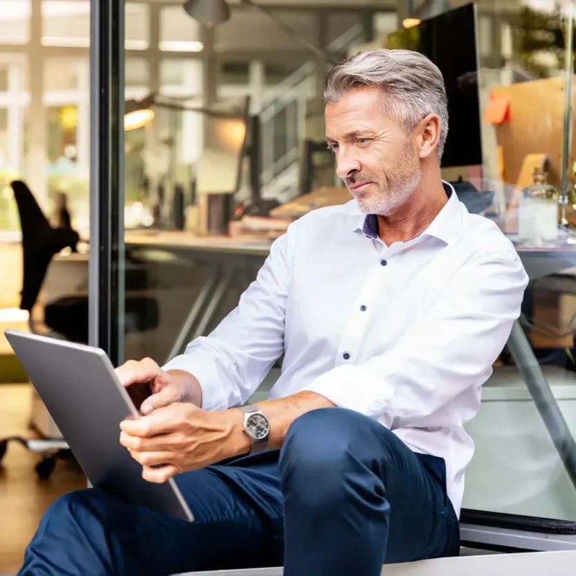 businessman-working-on-digital-tablet-while-sitting-1292019846-1040x1040-c-center businessman working on digital tablet while sitting