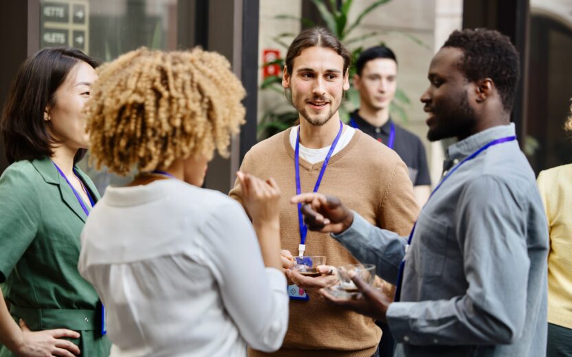 Business professionals having a casual chat after successful conference event People talking and networking