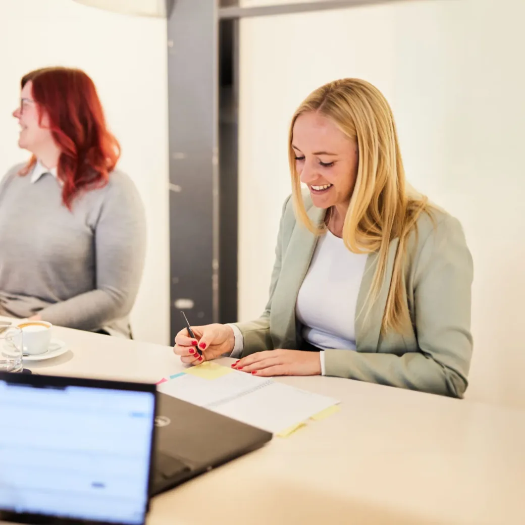 valantic employee writing notes in meeting valantic employee writing notes in meeting